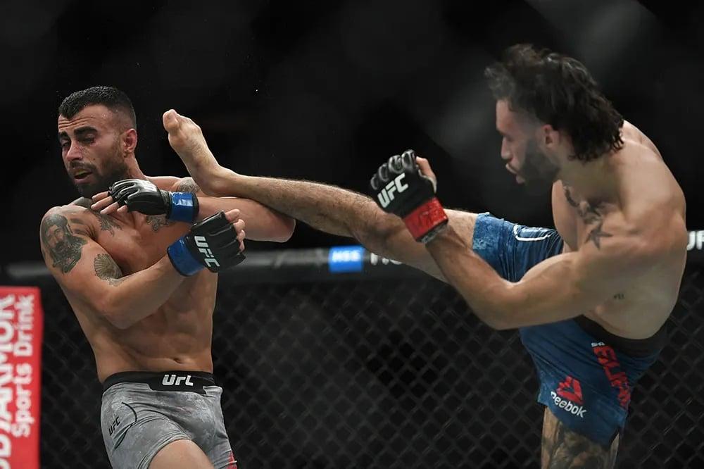 Shane Burgos landing a headkick on Makwan Amirkhani before finishing him in the third. Credits to: Sarah Stier - USA TODAY Sports.