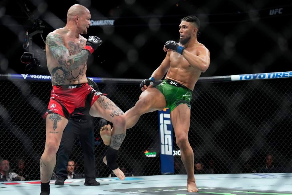 Johnny Walker slamming a leg kick onto Anthony Smith. Credits to: Jim Dedmon - USA TODAY Sports.