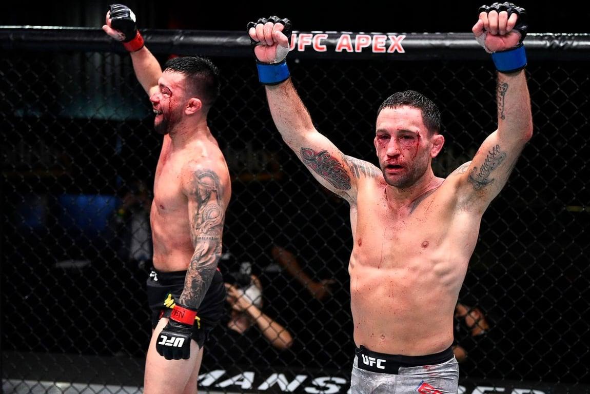 Frankie Edgar and Pedro Munhoz raise their hands after going to war for 5 rounds. Credits to: Zuffa LLC