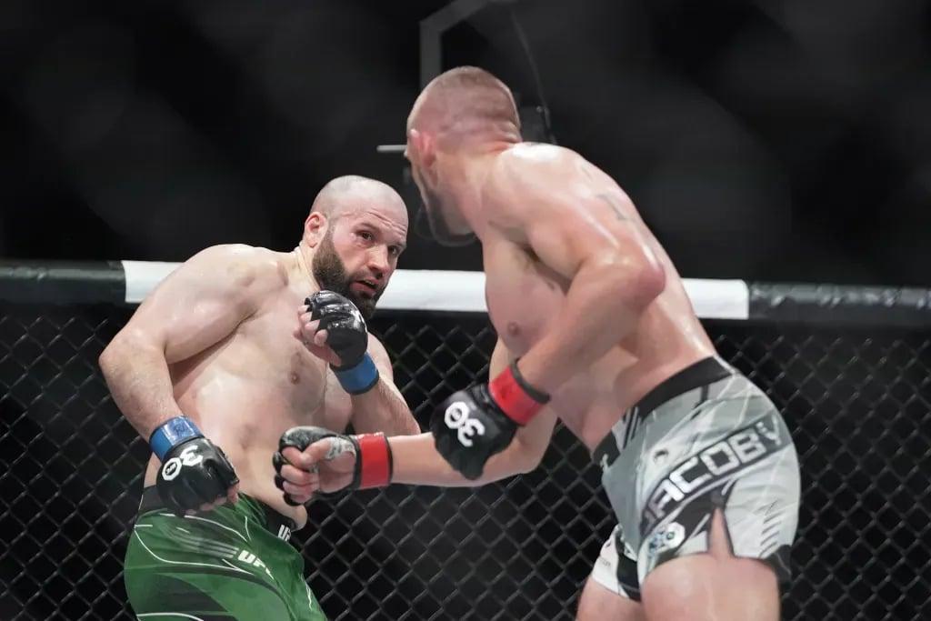 Azamat Murzakanov evading Dustin Jacoby. Credits to: Denny Medley - USA TODAY Sports.