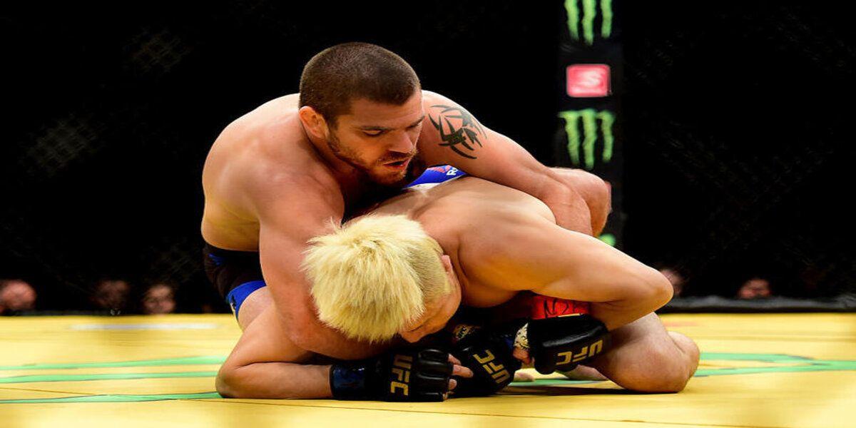 Jim Miller (top) wrestles with Takanori Gomi of Japan in their lightweight bout during the UFC 200 event on July 9, 2016 at T-Mobile Arena in Las Vegas, Nevada. (Photo by Harry How/Zuffa LLC.