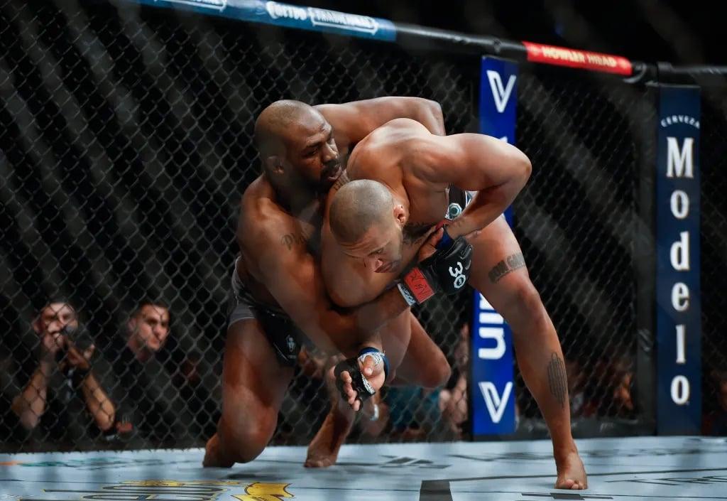 Jon Jones ragdolling Ciryl Gane after his three year layoff at UFC 285. Credits to: AP Photo - David Becker.
