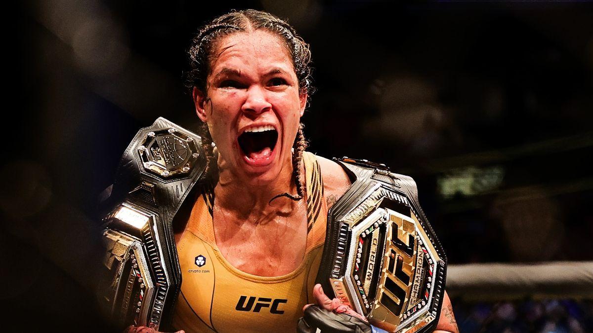 Amanda Nunes celebrates with her 2 belts. Credit: Getty Images.