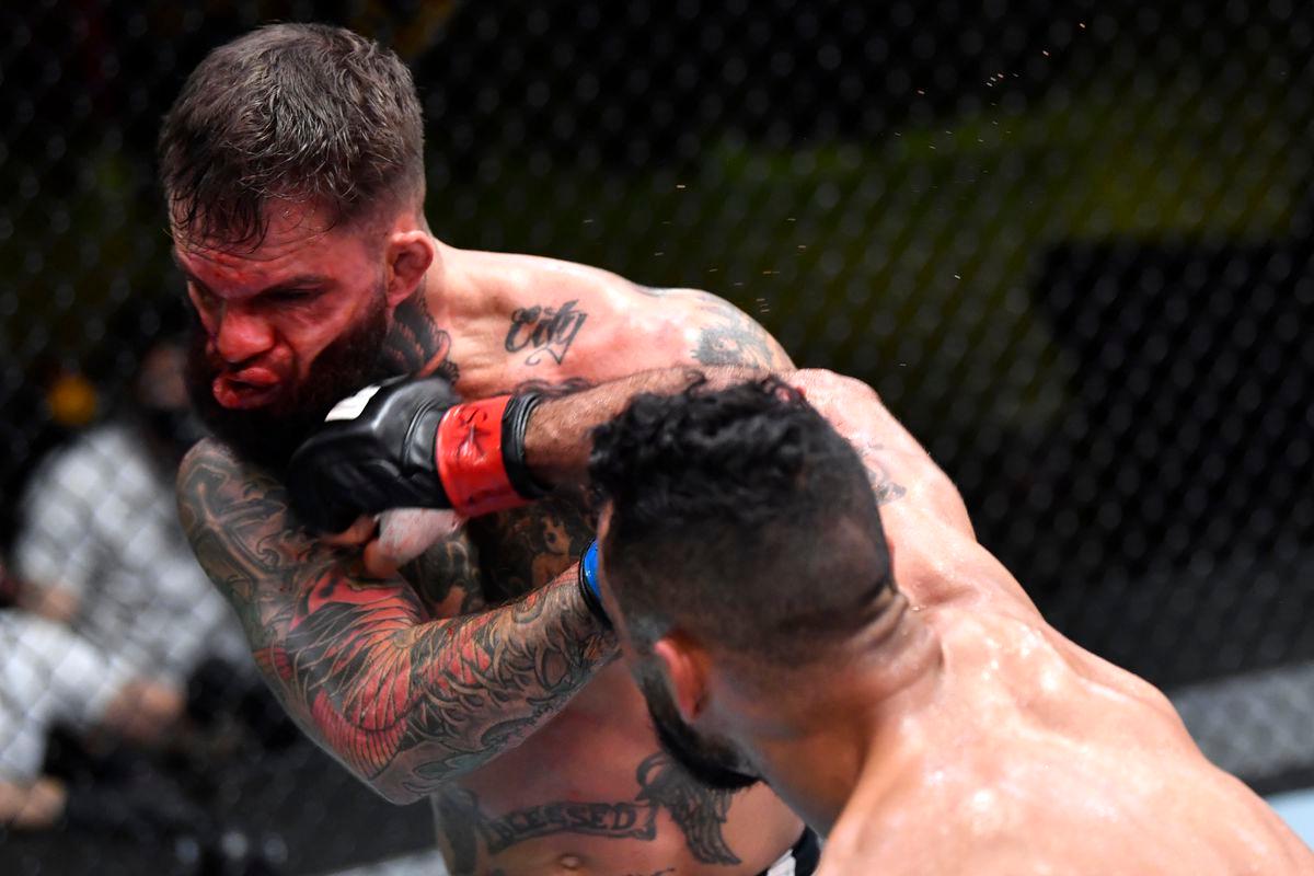 Rob Font blasts Cody Garbandt with a right hand. Credit: MMA Mania.