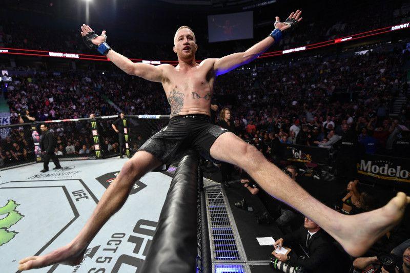 Justin Gaethje celebrates atop the cage. Credit: Jeff Bottari - Getty Images.