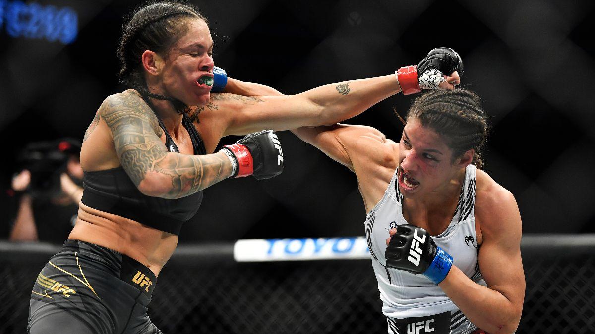 Julianna Pena times an overhand on Amanda Nunes. Credit: Action Network.