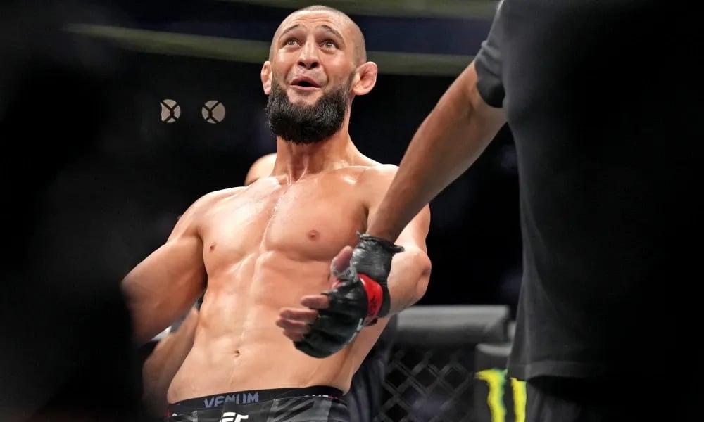 Khamzat Chimaev getting his hand raised against Kevin Holland. Photo by MMAJunkie.