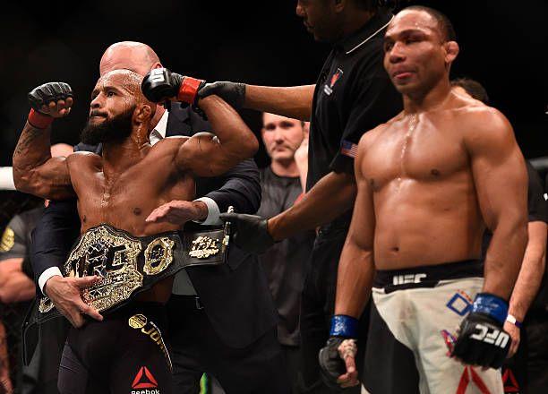 Demetrious Johnson getting the championship belt wrapped around his waist by Dana White after defeating John Dodson at UFC 191. Photo by Jeff Bottari, Zuffa LLC.
