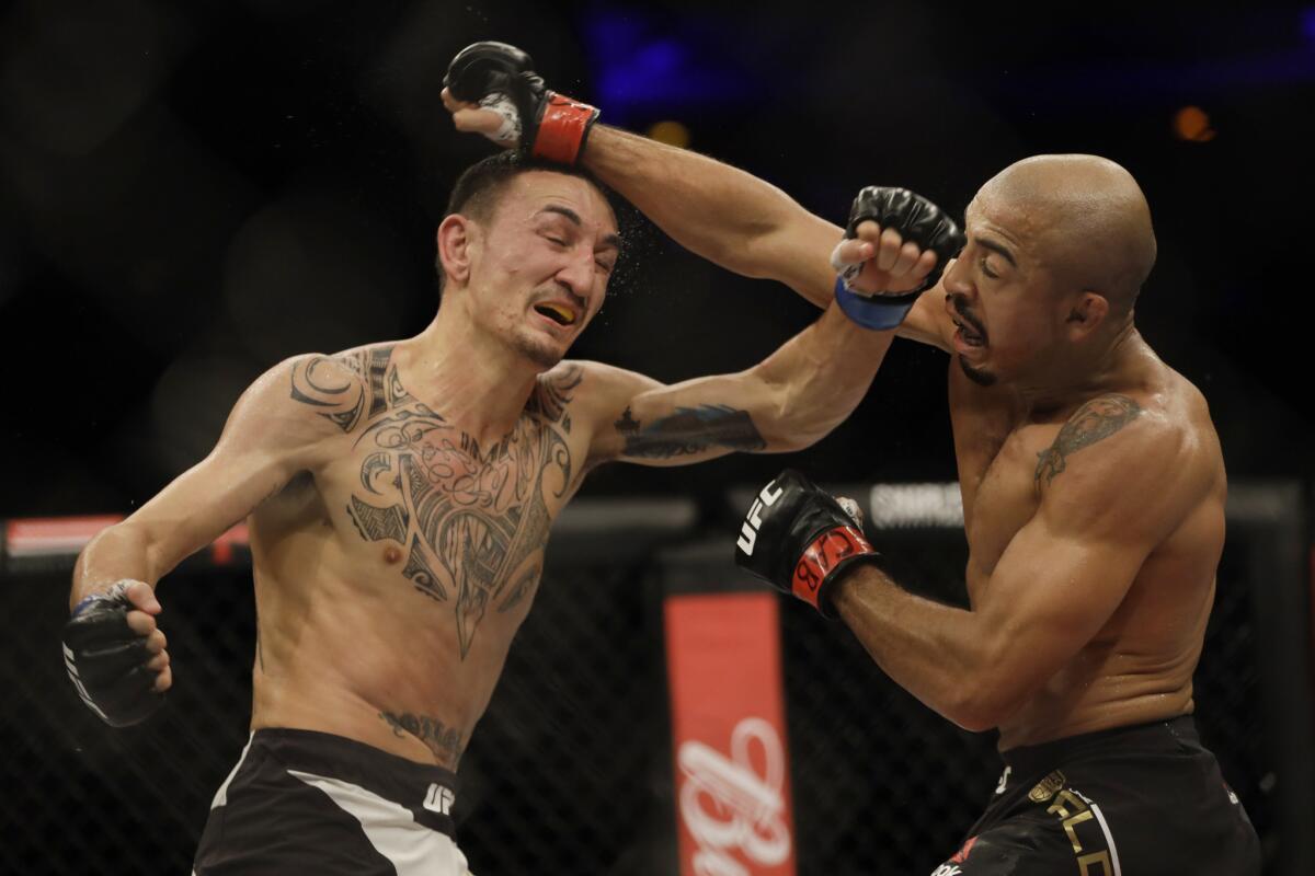 Max Holloway and Jose Aldo go toe to toe. Credit: LA Times.