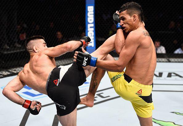 Ricardo Lamas throws a spinning kick at Charles Oliveira. Credit: Zuffa LLC.