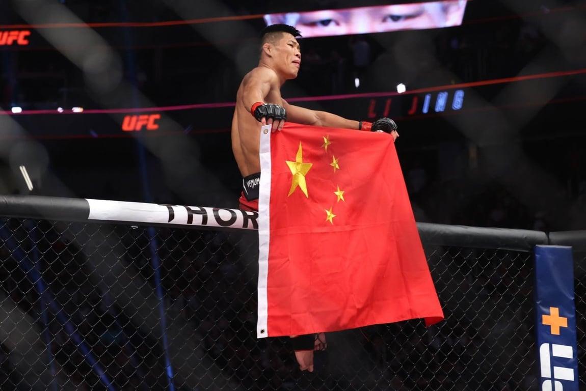Li Jingliang proudly represents China after finishing Muslim Salikhov. Credits to: Ed Mulholland USA-TODAY Sports