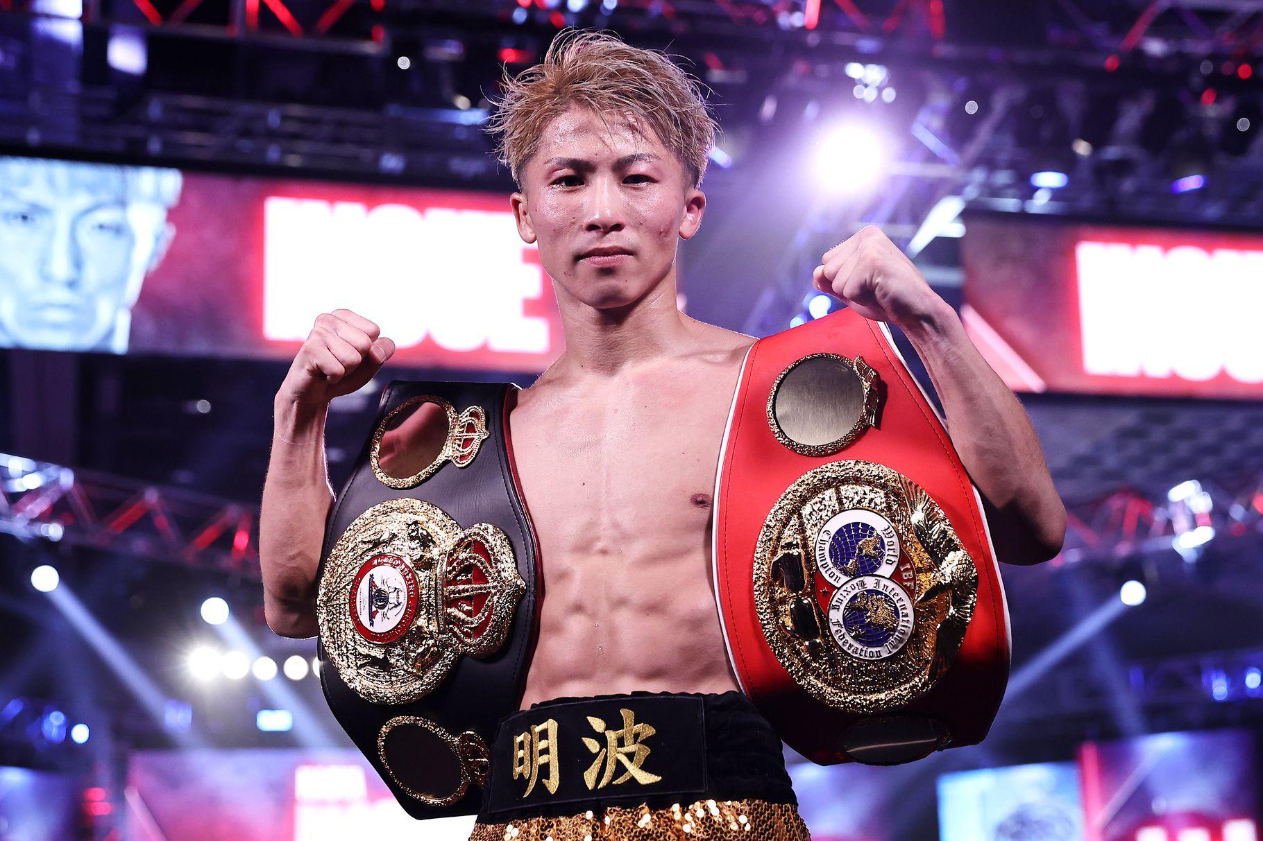 Naoya Inoue poses with two of his titles.  Credits to: Mikey Williams-Top Rank Inc via Getty Images.