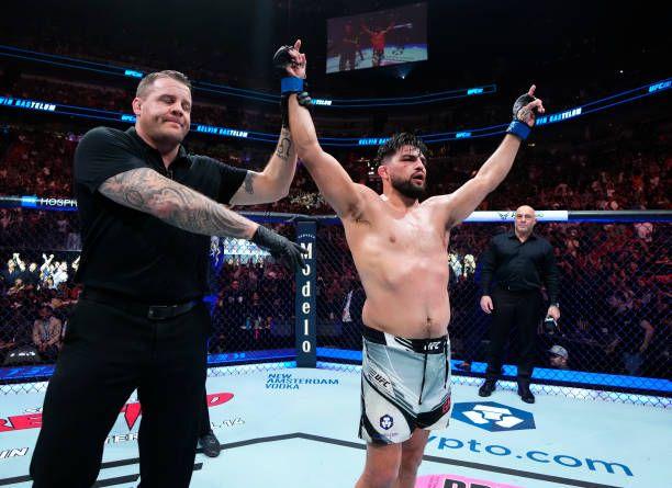 Kelvin Gastelum getting his hand raised at UFC 287. Credits to: Jeff Bottari-Zuffa LLC.
