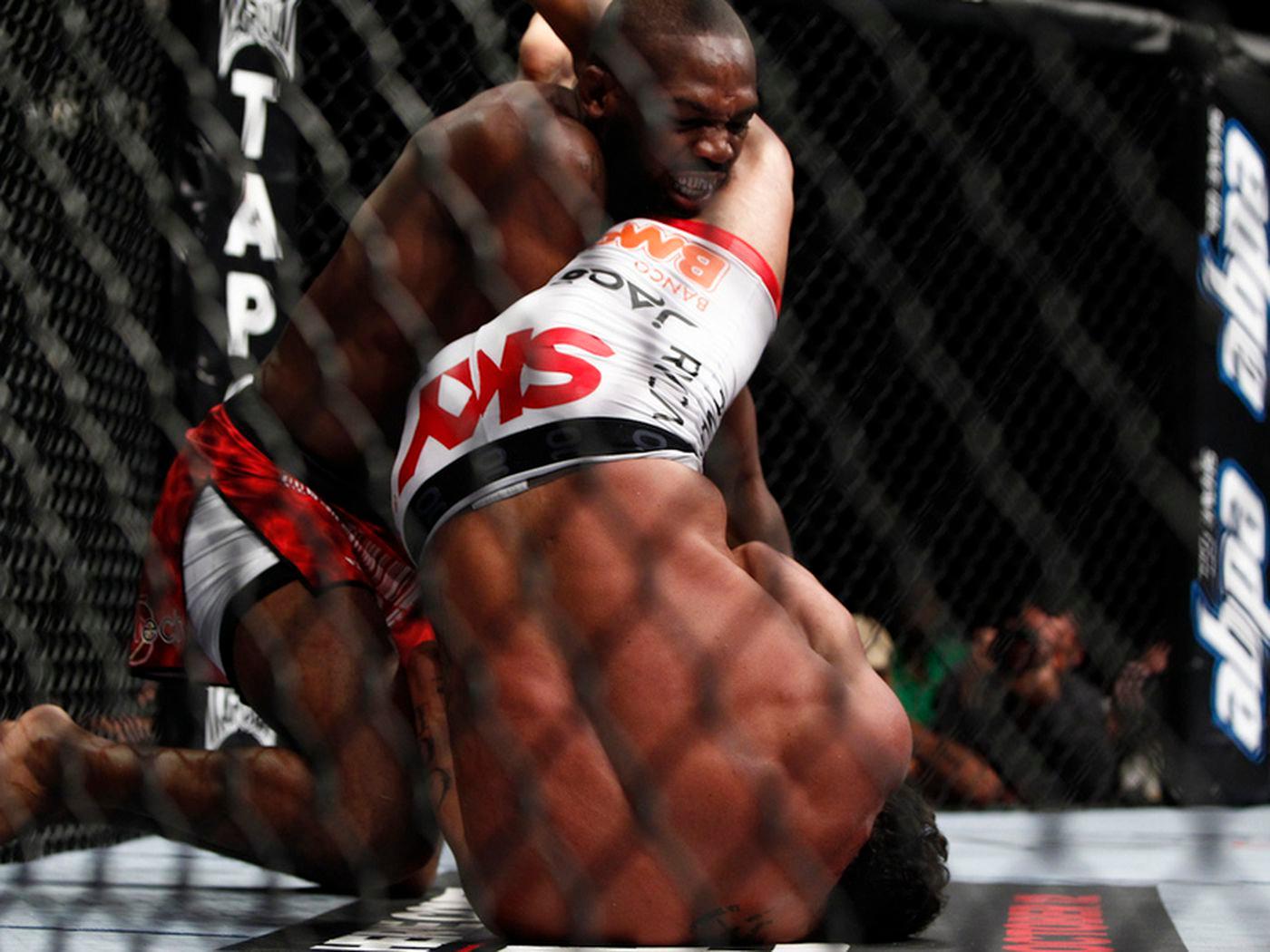Jon Jones escapes an armbar from Vitor Belfort to go on and win. Photo by Esther Lin, MMAFighting.