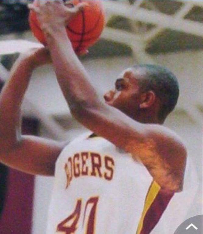 Hill attempting a jump shot in High School