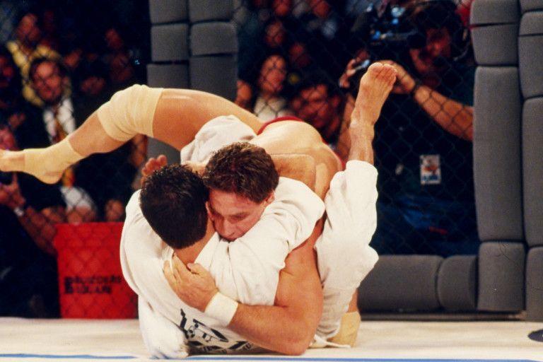 Ken Shamrock grappling with Royce Gracie at UFC 1. Credit: Holly Stein/Getty Images.