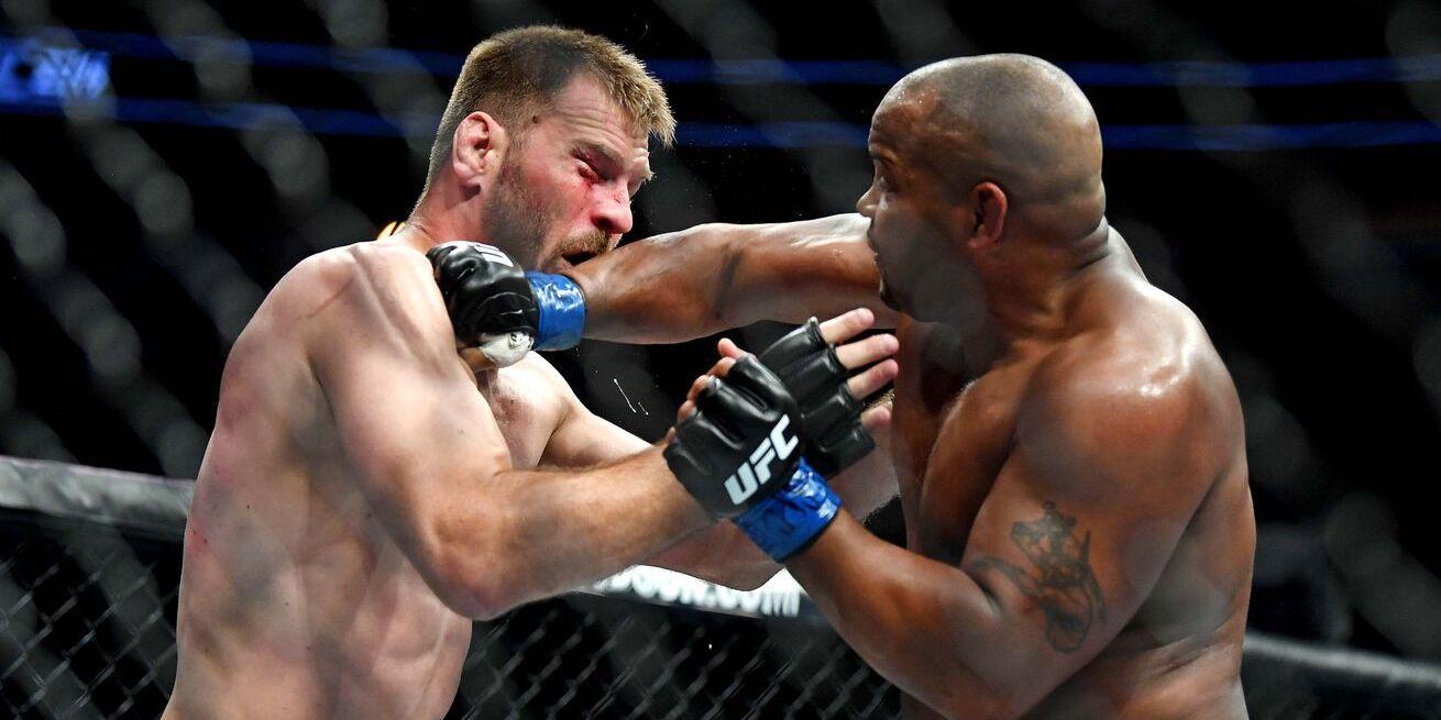 Daniel Cormier catching Stipe Miocic. Credits to: Stephen R. Sylvanie - USA TODAY Sports.