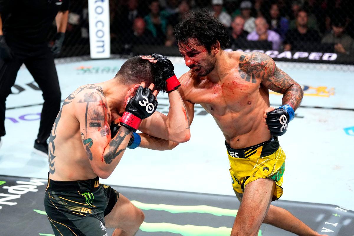 Alexandre Pantoja throws an uppercut at Brandon Moreno. Credit: MMA Fighting.