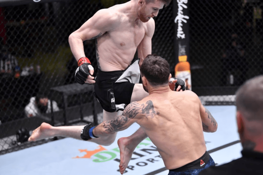 Cory Sandhgaen lands a flying knee against Frankie Edgar. Getty Images
