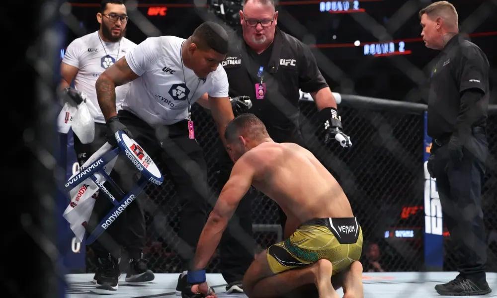 Gilbert (left) cornering his brother Herbert (right). Photo by MMAJunkie.