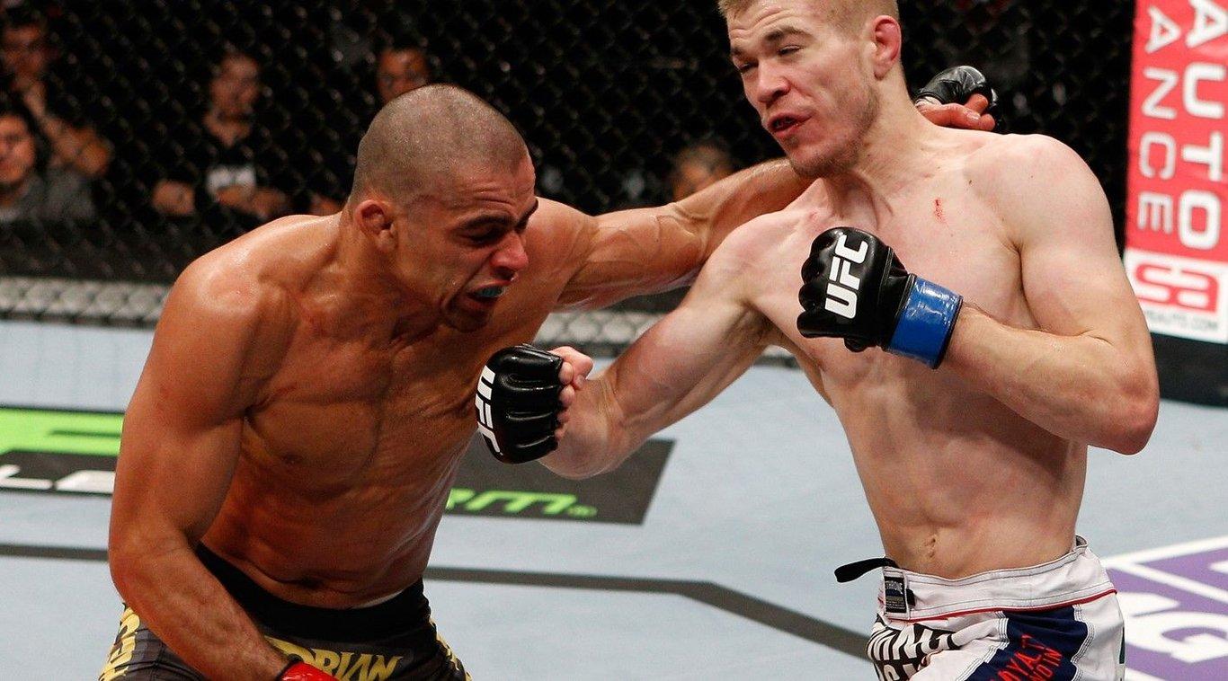 Michael McDonald striking Renan Barão in his Bantamweight title fight. Credits to: Josh Hedges - Zuffa LLC.
