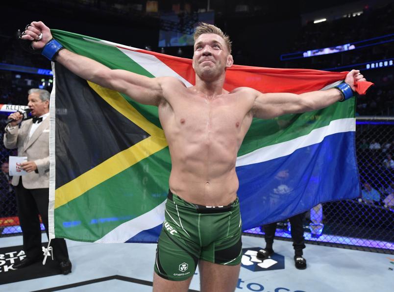 Dricus Du Plessis holding the South African flag. Credits to: Jeff Bottari - Zuffa LLC.