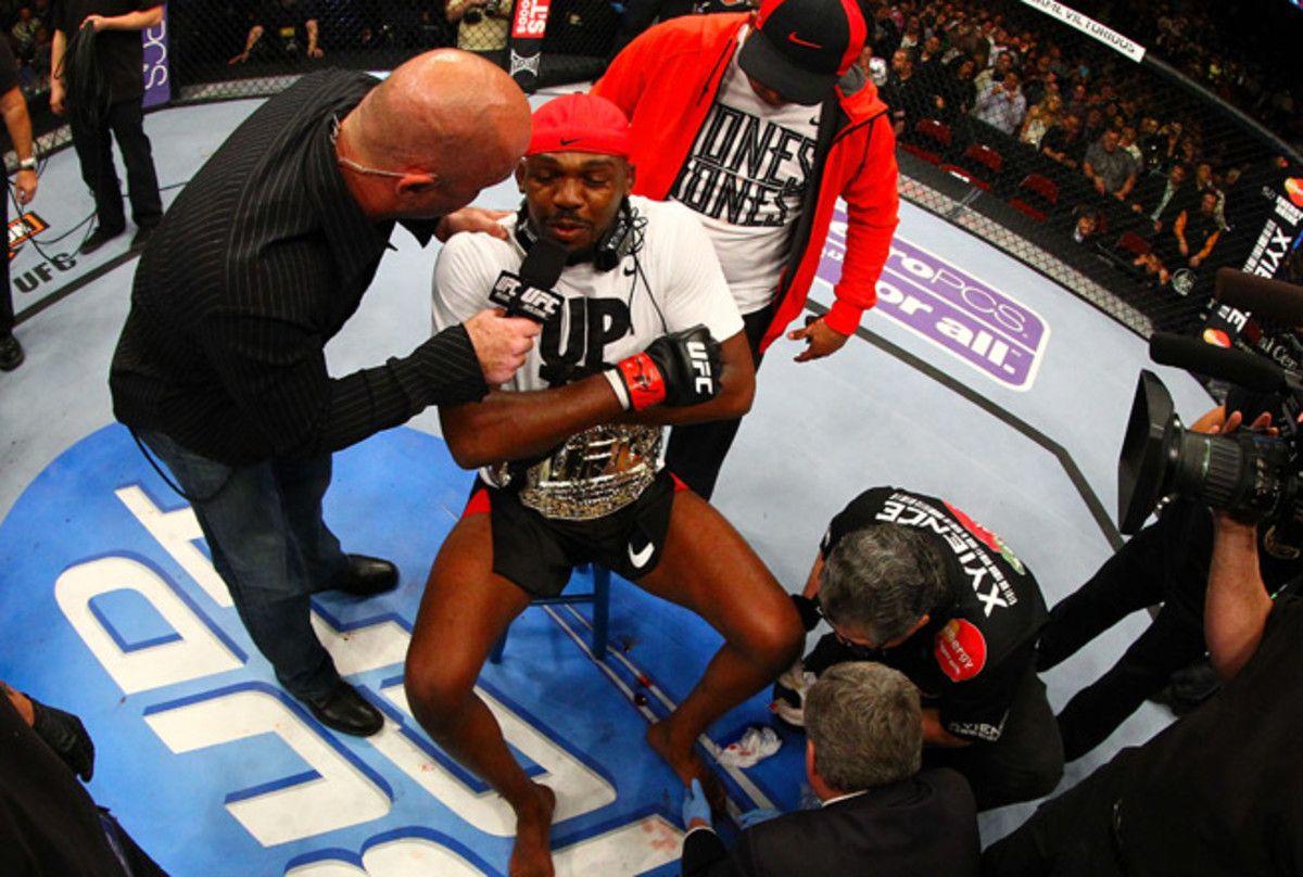 Jon Jones getting his broken toe checked out in the octagon after finishing Chael Sonnen in the first round of their title fight. Photo by Al Bello, Zuffa LLC.
