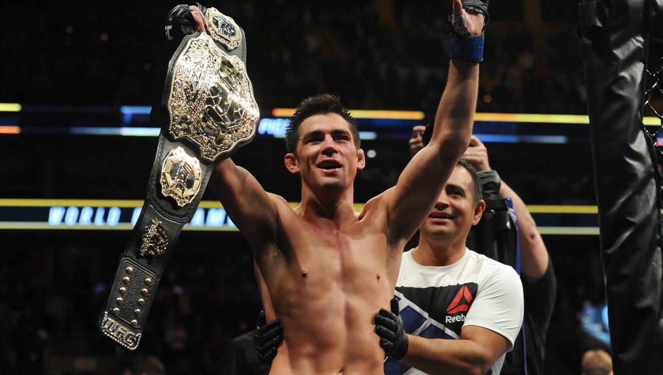 Dominick Cruz raising his UFC Championship after defeating TJ Dillashaw. Credits to: Bob Chiara-USA TODAY Sports.