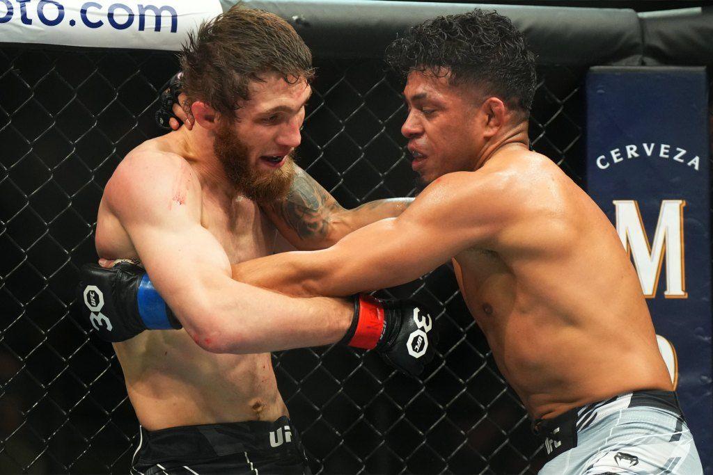 Jonathan Martinez utilising the clinch vs. Said Nurmagomedov. Credits to: Ron Chenoy - USA TODAY Sports.