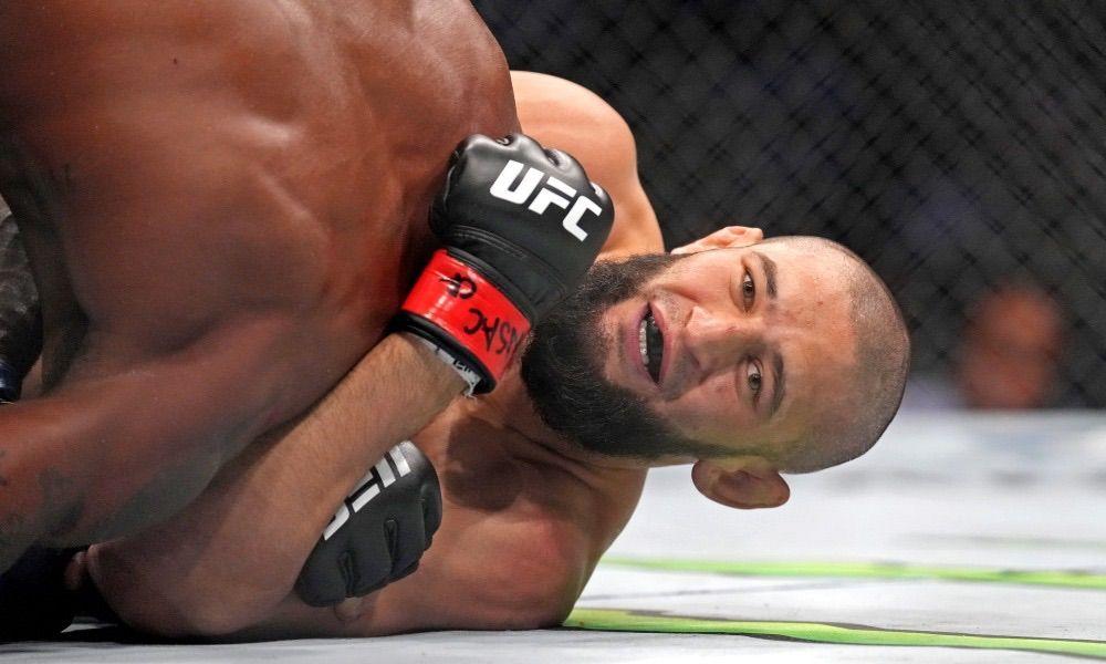 Khamzat Chimaev happily choking Kevin Holland at UFC 279. Credits to: Zuffa LLC.