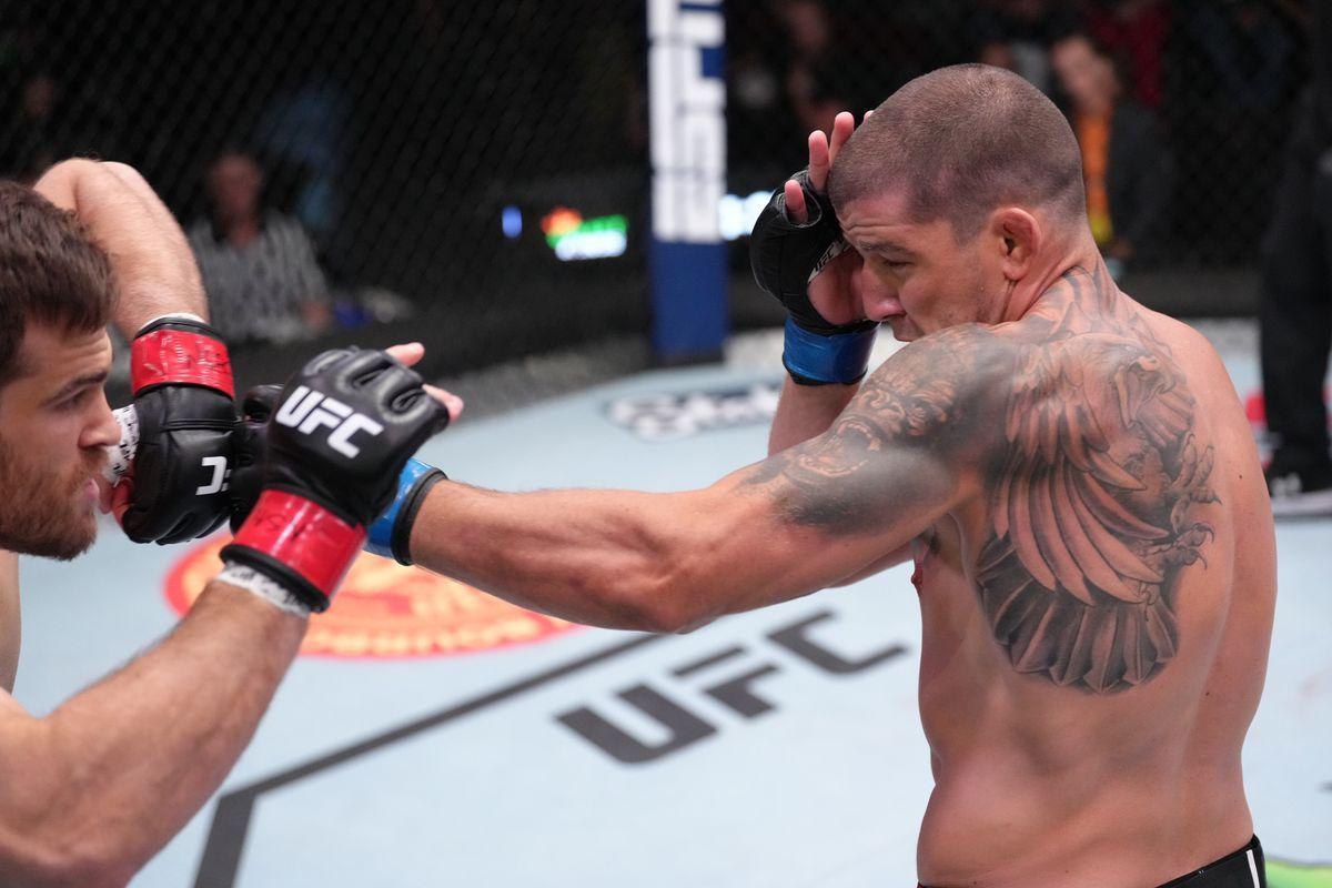 Marc Andre- Barriault throws a hook at Julian Marquez. Credit to: Zuffa LLC.