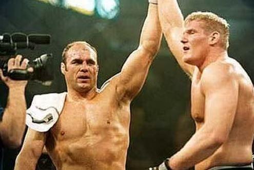 Randy Couture raising Josh Barnett's after their fight. Credits to: Paul Benson - SportSkeeda.