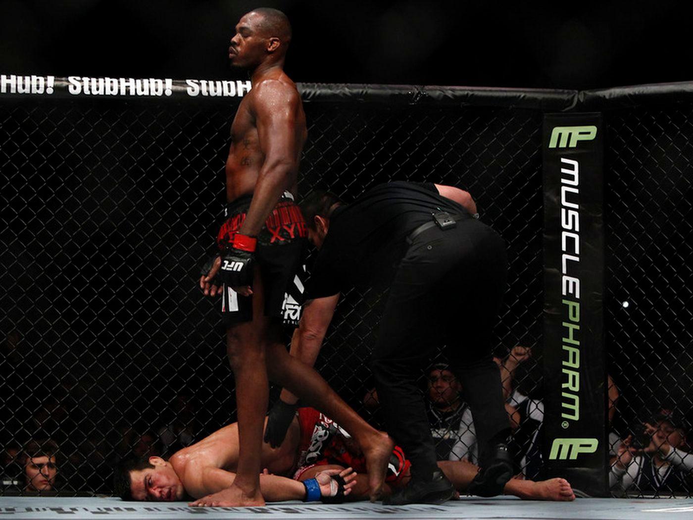 Jon Jones walks off after rendering Lyoto Machida unconscious. Photo by Esther Lin, MMAFighting.