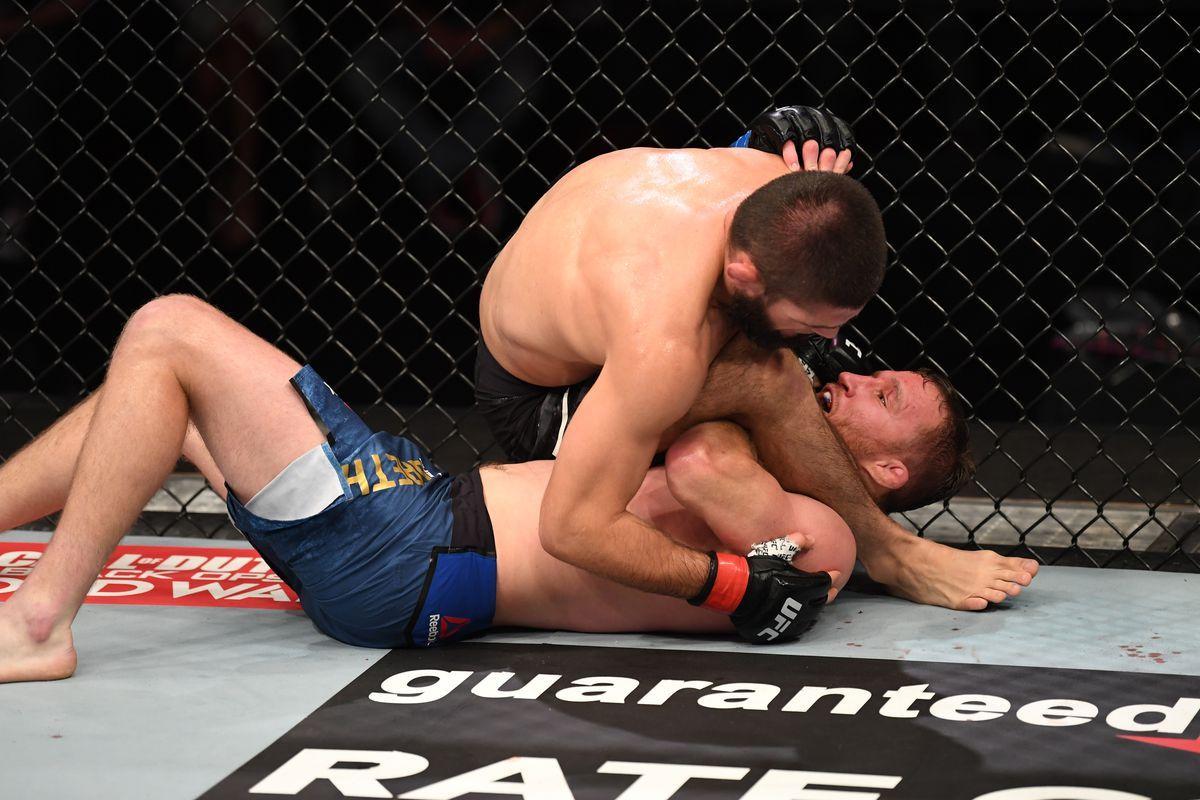Khabib Nurmagomedov sinks in a triangle choke on Justin Gaethje. Credit: MMA Fighting.