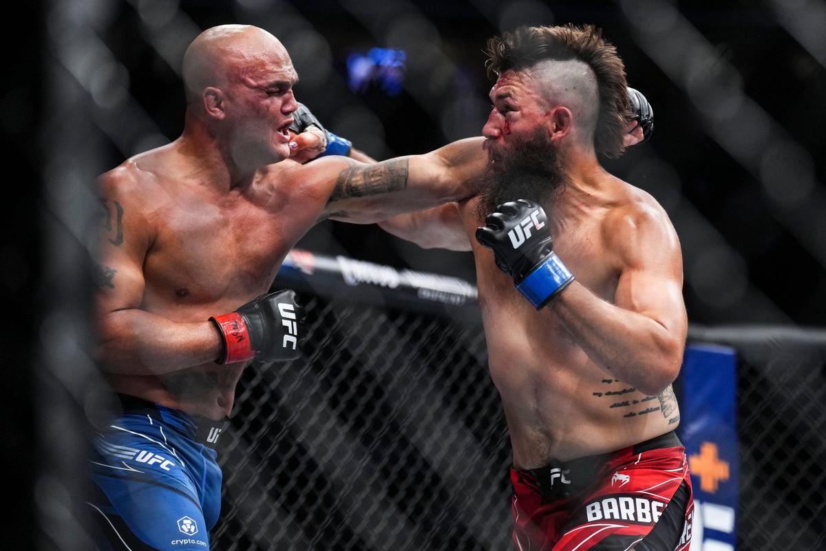 Bryan Barberena exchanges punches with Robbie Lawler. Credit: MMA Fighting.