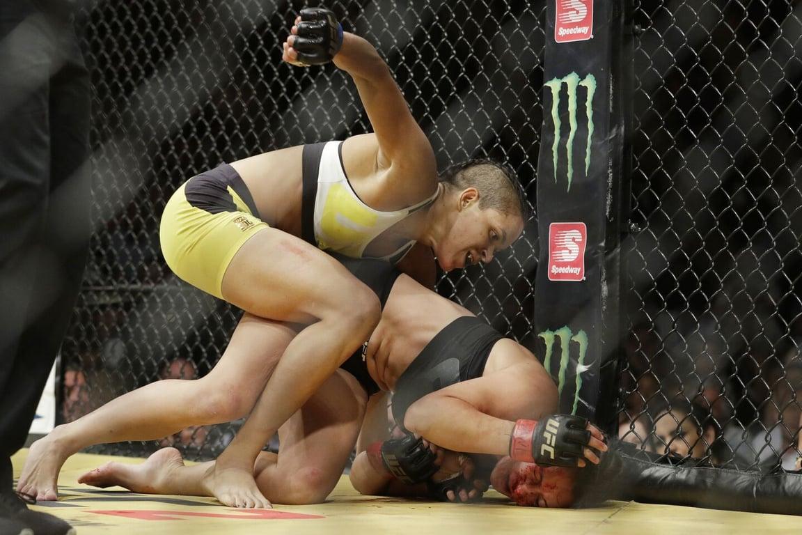 Amanda Nunes dominating Meisha Tate to become the UFC Champion. Credits to: John Locher - Associated Press.