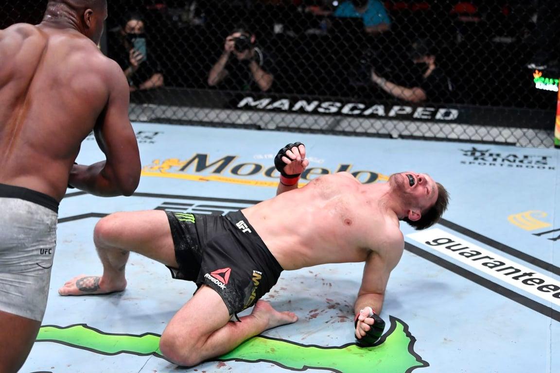 Stipe Miocic drops while Francis Ngannou begins to pounce on him. Jeff Bottari/Getty Images