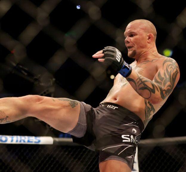 Anthony Smith kicks Magomed Ankalaev at their fight back at UFC 277. Credits to: Carmen Mandato - Zuffa LLC