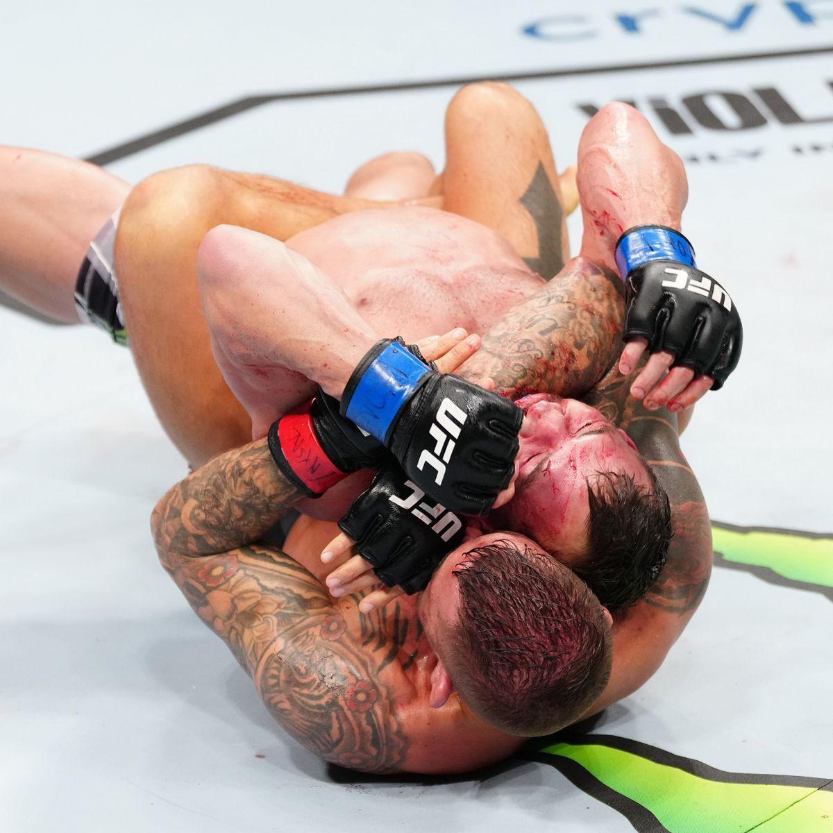 Dustin Poirier takes Michael Chandler's back during his submission win. Credits to: Zuffa LLC.