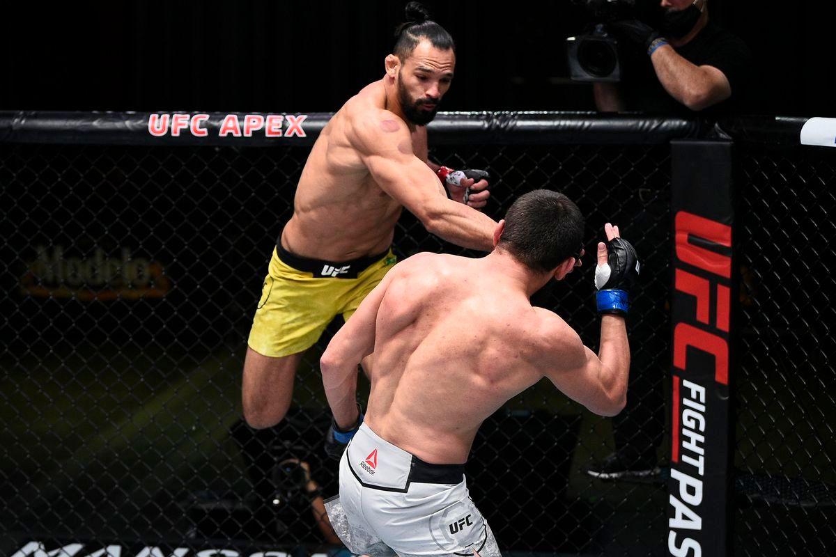 Michel Pereira launches off the cage to punch Zelim Imadaev. Credit: MMA Fighting.