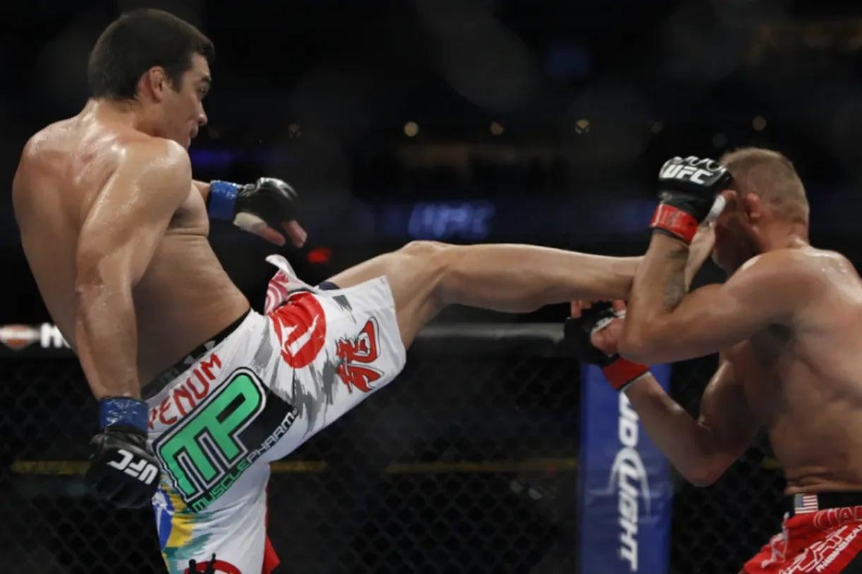 Lyoto Machida front kicks Randy Couture in the face. Credit: Esther Lin - MMAFighting.