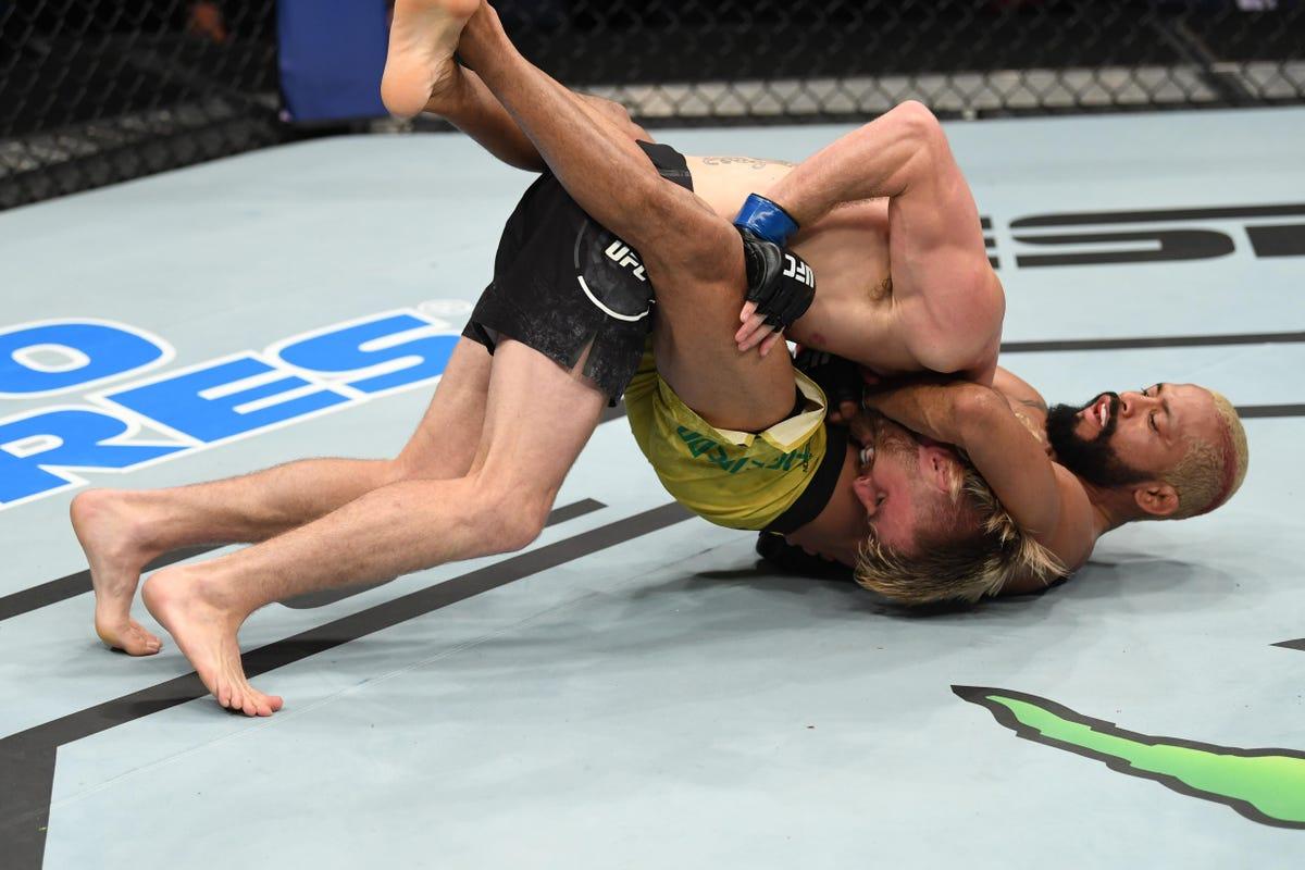 Deiveson Figueiredo submits Tim Elliott on the prelims, earning a title fight in his next fight. Photo by Forbes.