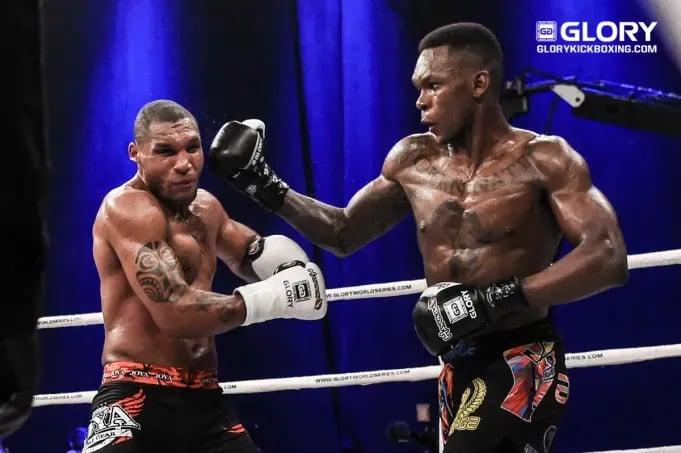 Israel Adesanya landing a right hook against Jason Wilnis in Kickboxing. Credits to: James Law-GLORY Sports