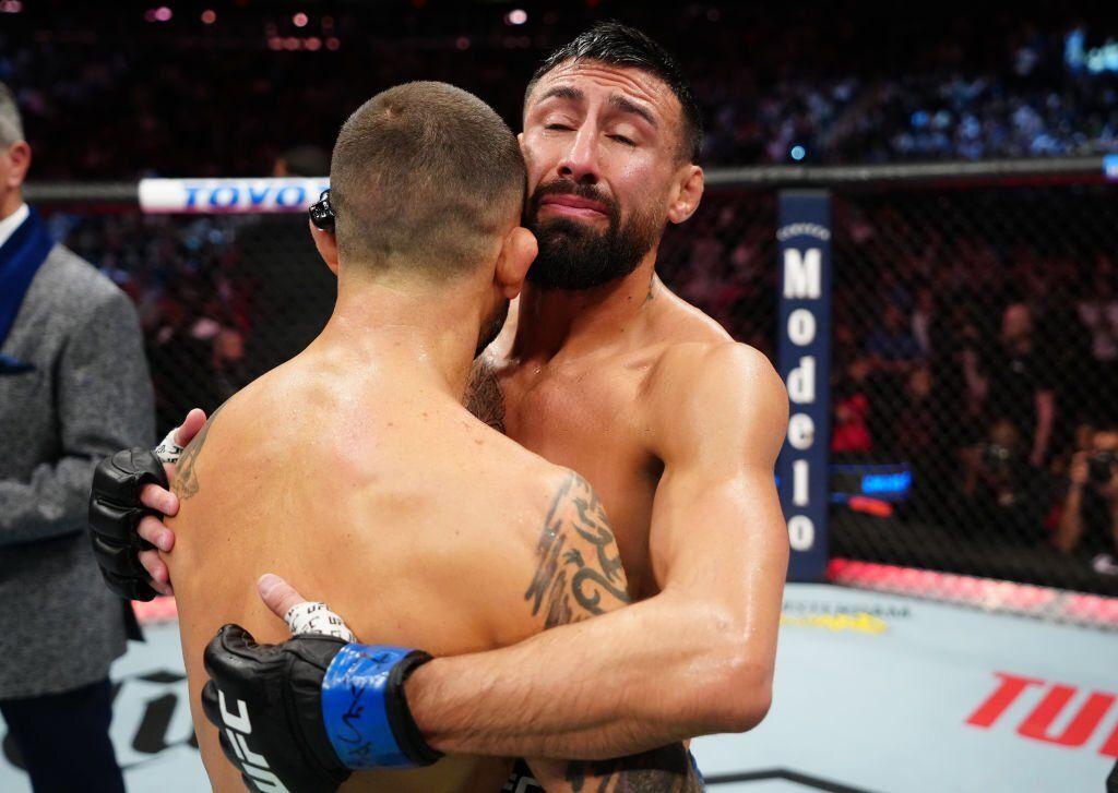 Chris Gutierrez embraces Frankie Edgar at their fight at UFC 281. Credits to: Jeff Bottari - Zuffa LLC