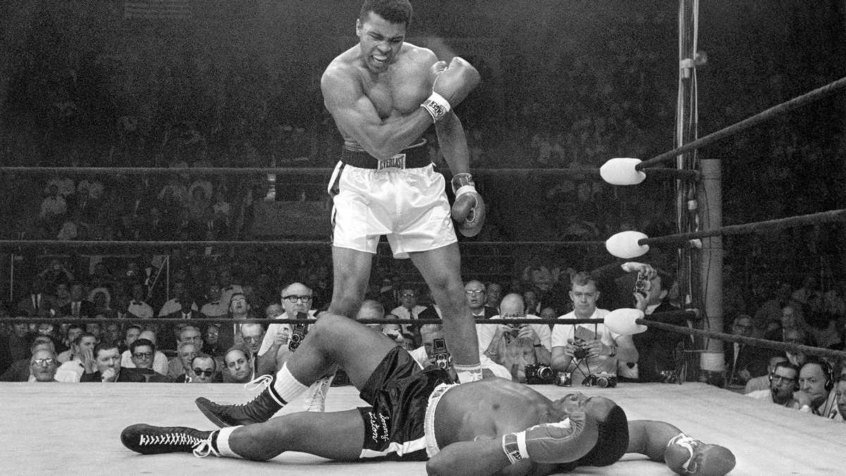 Muhammad Ali standing over Sonny Liston in their rematch. Credits to: Neil Leifer