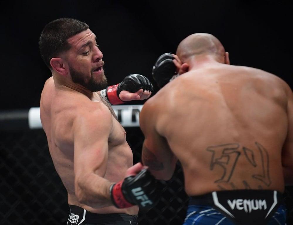 Nick Diaz throwing a body hook against Robbie Lawler in their rematch. Credits to: Gary A. Vasquez - USA TODAY Sports.