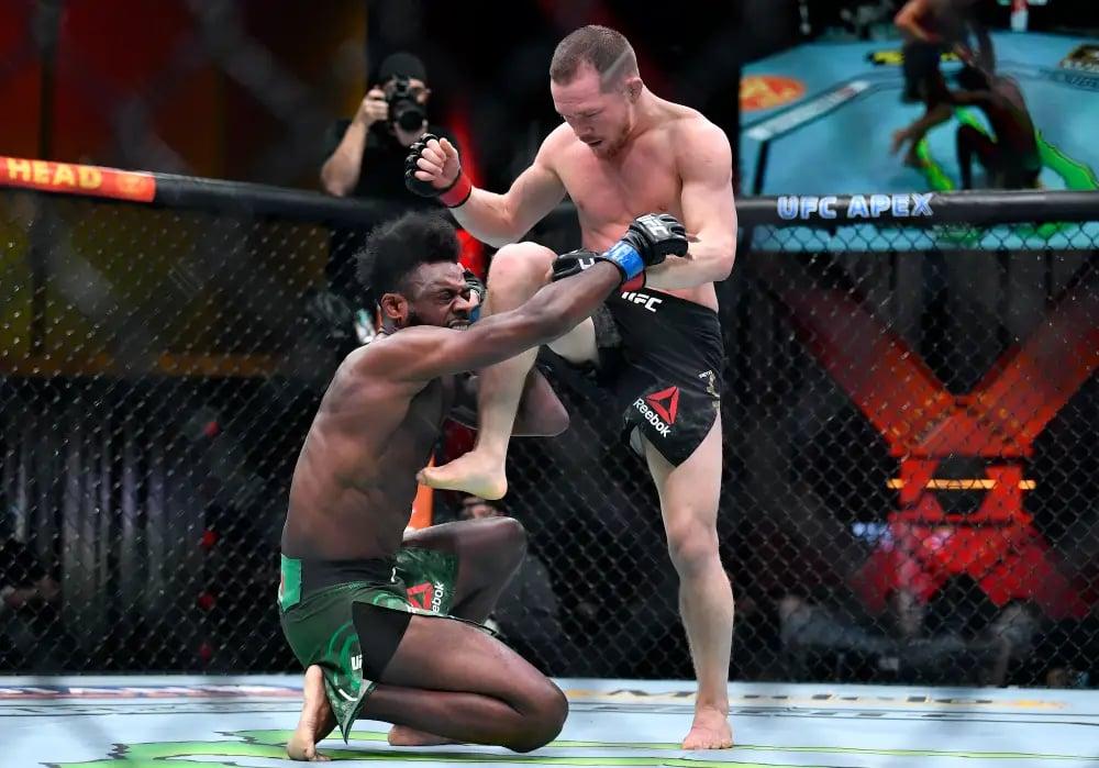 Petr Yan hits Aljamain Sterling with an illegal knee. Chris Unger/Getty Images
