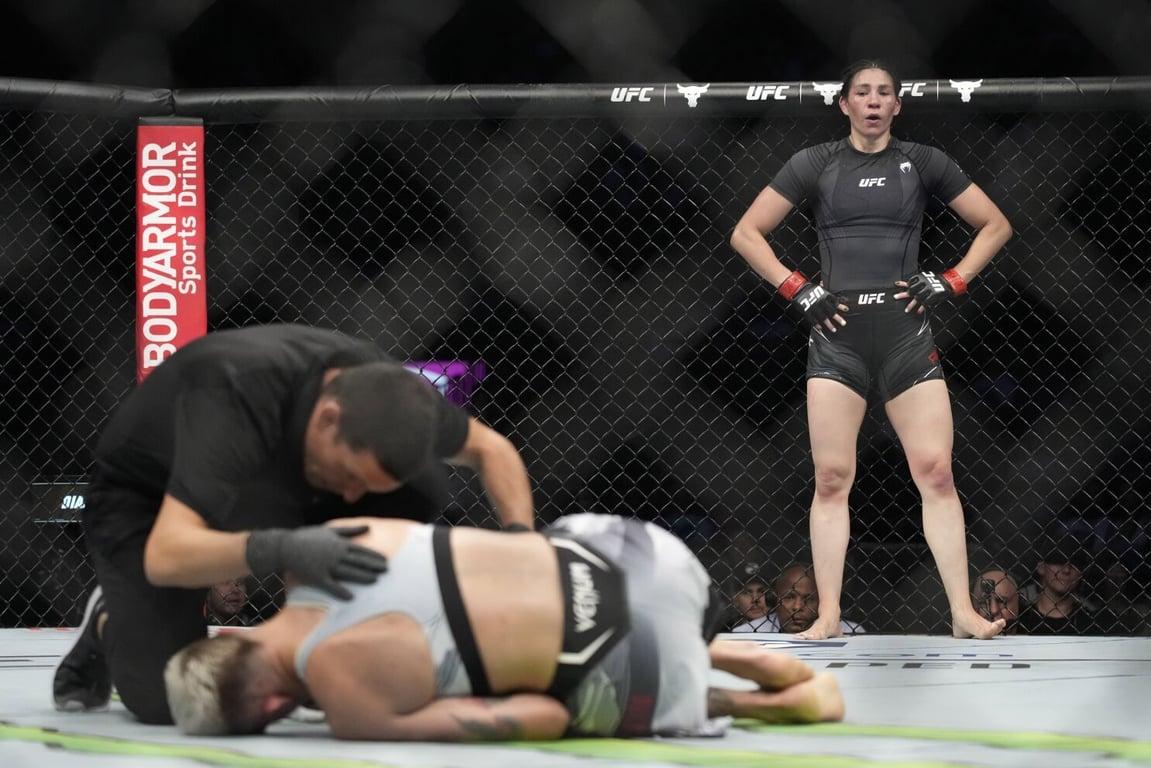 Irene Aldana standing over Macy Chiasson after her crazy liver-kick TKO. Credits to: Joe Camporeale - USA TODAY Sports.