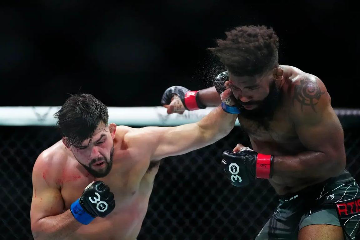 Kelvin Gastelum clipping Chris Curtis in their Fight of The Night bout. Credits to: Rich Storry - USA TODAY Sports.