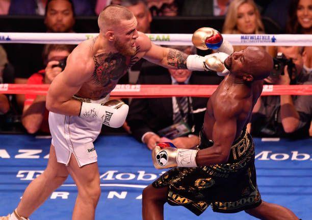 Conor McGregor lands a straight left against Floyd Mayweather. Credits to: Jeff Bottari-Getty Images.